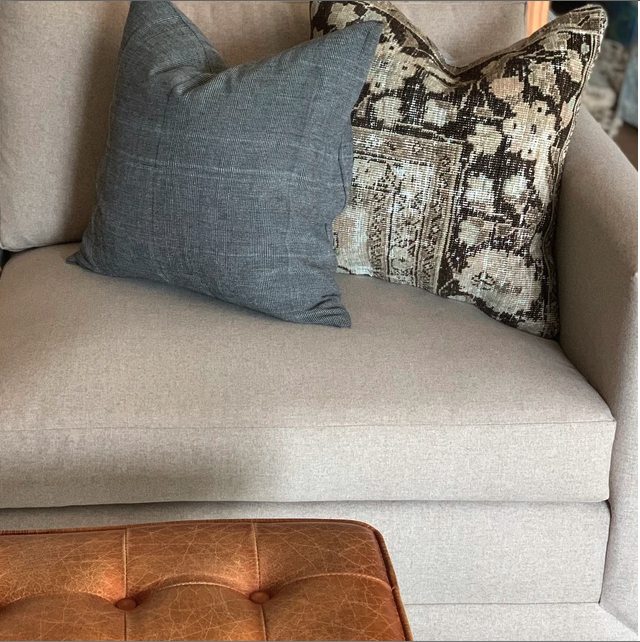 Silk pillow cover on gray sofa