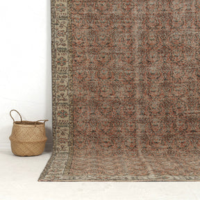 Authentic 6x10 area rug from turkish, in subtle orange tones