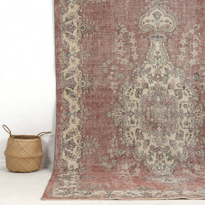 Authentic 6x10 area rug from turkish, in subtle pink tones