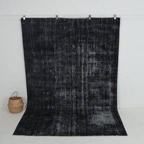 Handmade 7x10 area rug in black, ideal for a cozy living room, bedroom, dining room, entryway, office