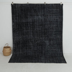 Handmade 7x9 area rug in black, ideal for a cozy living room, bedroom, dining room, entryway, office